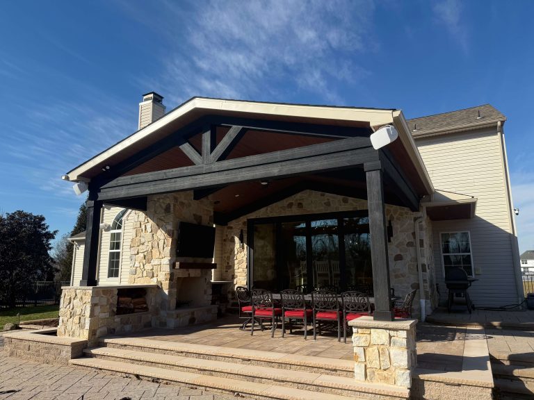 Stone and timber covered patio addition with gable roof attached to South Jersey home