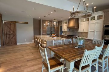Custom kitchen renovation with large island, white oak floors and chandelier by South Jersey contractor