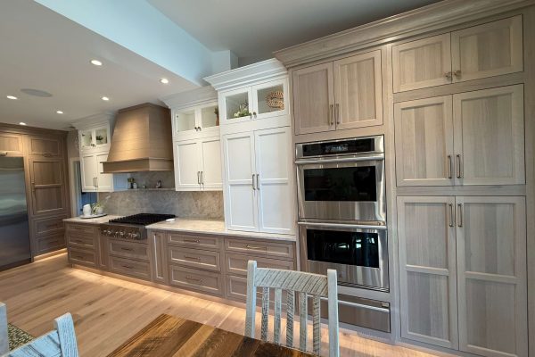 Custom kitchen cabinetry with wood range hood and stainless double ovens in Gloucester County NJ